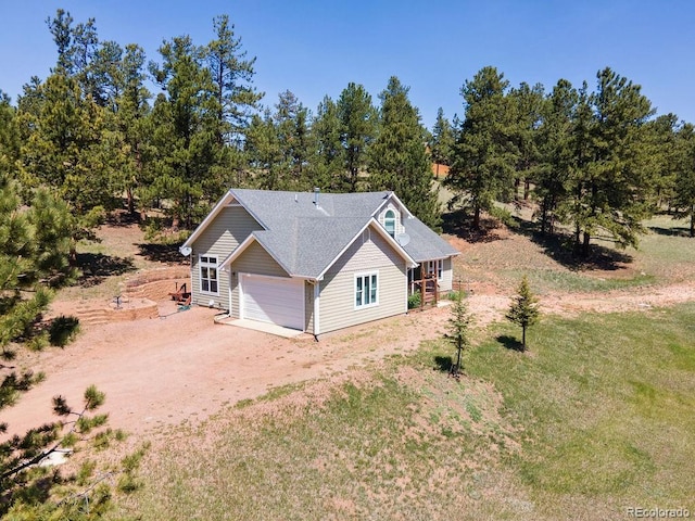 1563 Southpark Rd, Florissant, CO 80816 - view of home's exterior with driveway, view of scattered trees, and a garage