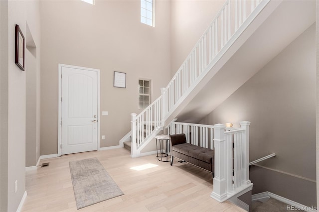 entrance foyer featuring light hardwood / wood-style floors and a high ceiling