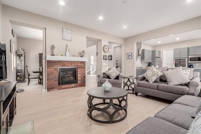 living room featuring a fireplace and light hardwood / wood-style floors