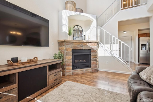 living room featuring hardwood / wood-style flooring and a fireplace