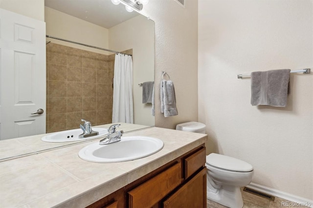 bathroom featuring curtained shower, toilet, and vanity