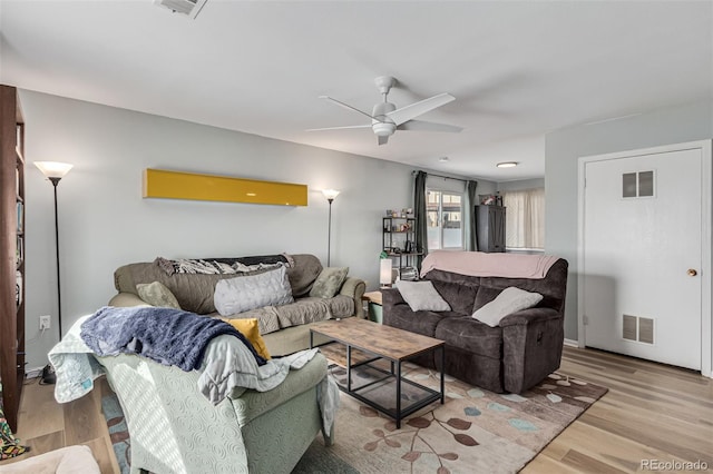 living room featuring ceiling fan and light wood-type flooring