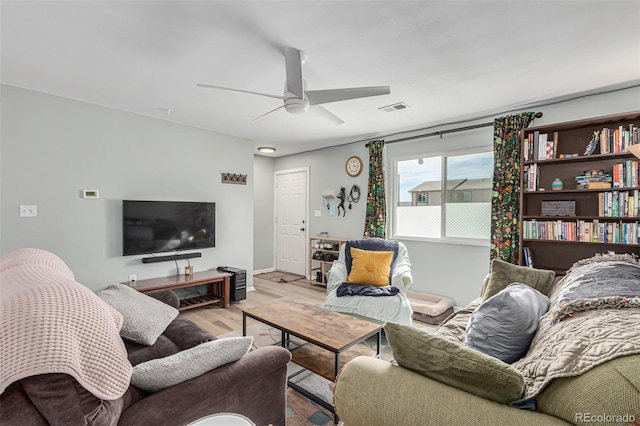 living room with light wood-type flooring and ceiling fan