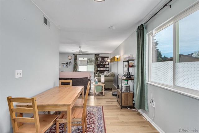 dining area with light hardwood / wood-style floors and ceiling fan