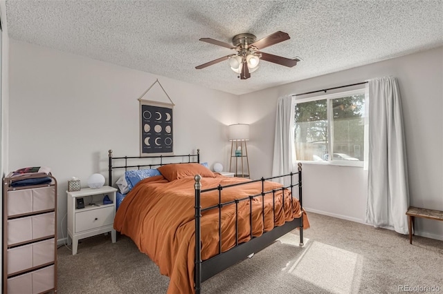 carpeted bedroom featuring a textured ceiling and ceiling fan