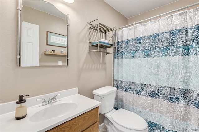 bathroom with vanity, toilet, and walk in shower