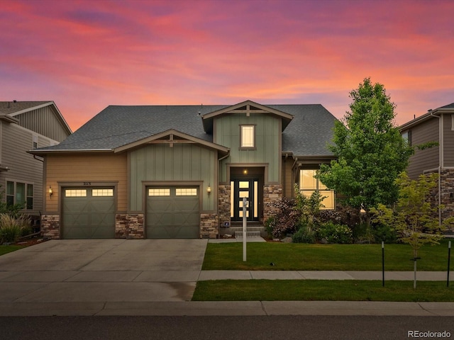 2113 Fountain Cir, Erie, CO 80516 - craftsman-style home with board and batten siding, driveway, a garage, a yard, and stone siding