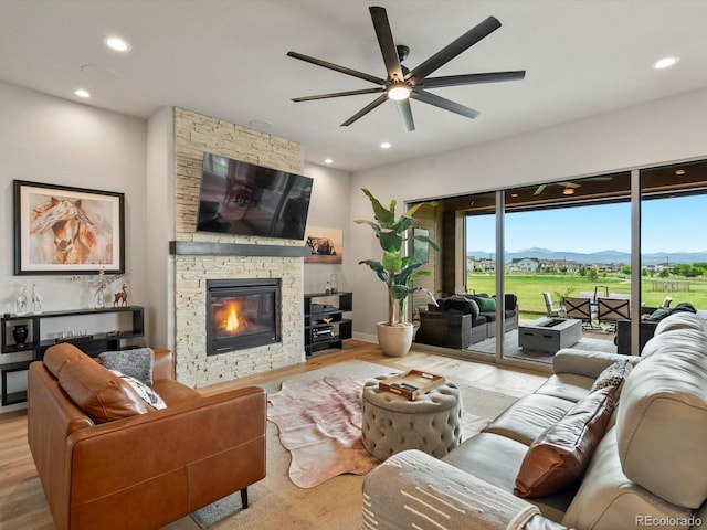 2113 Fountain Cir, Erie, CO 80516 - living room featuring a ceiling fan, wood finished floors, recessed lighting, a fireplace, and baseboards