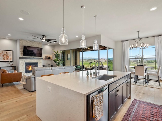 2113 Fountain Cir, Erie, CO 80516 - kitchen featuring dishwasher, a sink, a ceiling fan, a fireplace, and recessed lighting