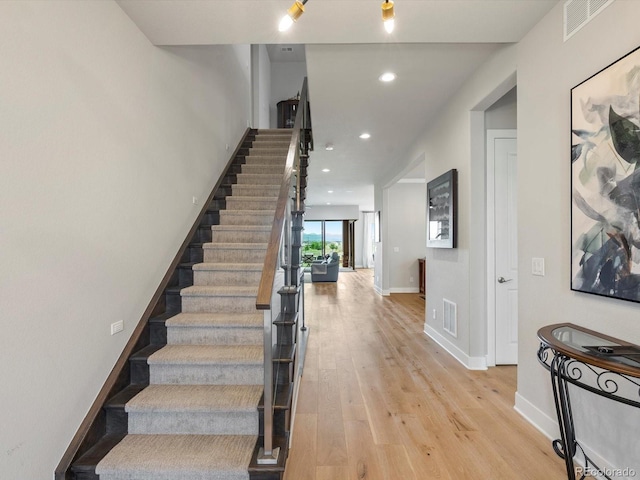 2113 Fountain Cir, Erie, CO 80516 - stairway with wood finished floors, recessed lighting, and baseboards