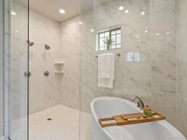 2113 Fountain Cir, Erie, CO 80516 - full bath featuring a freestanding bath, a walk in shower, and tile walls