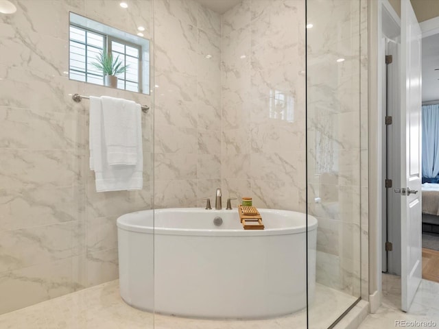 2113 Fountain Cir, Erie, CO 80516 - full bath with ensuite bathroom, a freestanding bath, marble finish floors, tile walls, and walk in shower