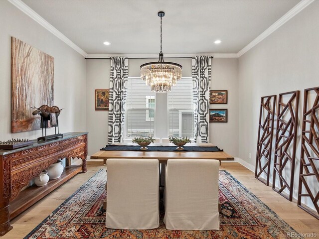 2113 Fountain Cir, Erie, CO 80516 - dining area featuring a chandelier, wood finished floors, crown molding, recessed lighting, and baseboards