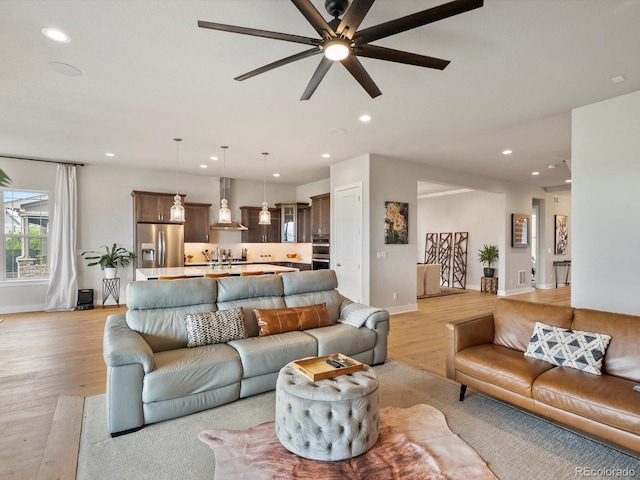 2113 Fountain Cir, Erie, CO 80516 - living area featuring baseboards, light wood-style flooring, a ceiling fan, and recessed lighting