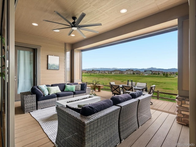 2113 Fountain Cir, Erie, CO 80516 - wooden deck featuring an outdoor living space, a ceiling fan, and a mountain view
