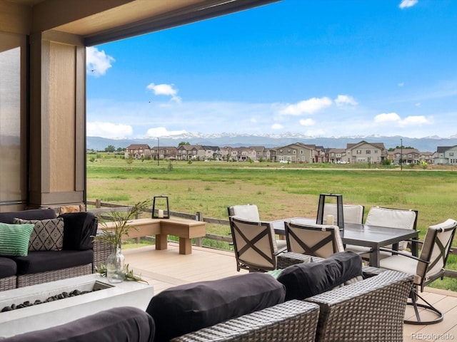 2113 Fountain Cir, Erie, CO 80516 - view of patio / terrace featuring a residential view, a deck with mountain view, outdoor dining area, and a fire pit
