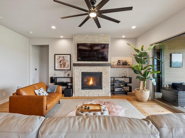 2113 Fountain Cir, Erie, CO 80516 - living room featuring ceiling fan, wood finished floors, a stone fireplace, and recessed lighting