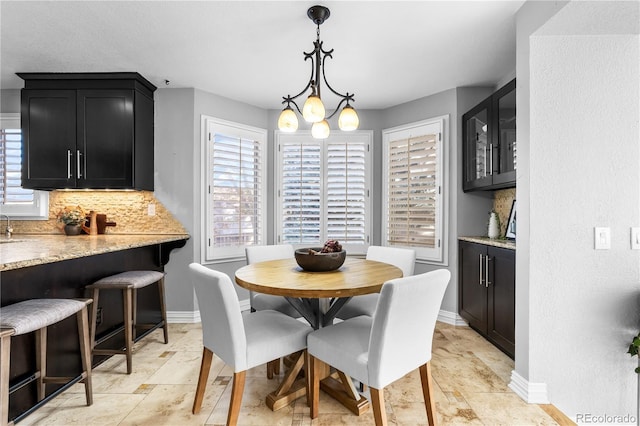 dining space featuring a healthy amount of sunlight and a notable chandelier