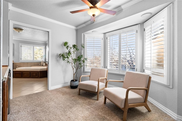 sitting room with crown molding, light tile patterned floors, a textured ceiling, and ceiling fan