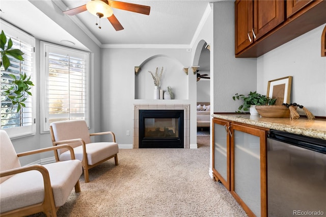 sitting room with crown molding, light colored carpet, and a textured ceiling