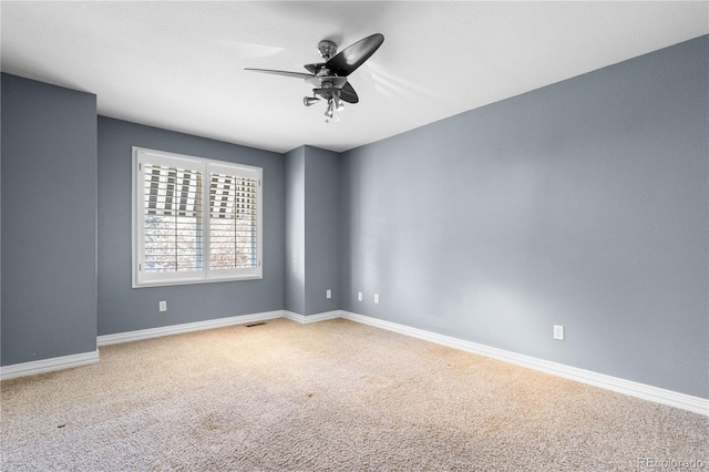 unfurnished room with ceiling fan and carpet floors