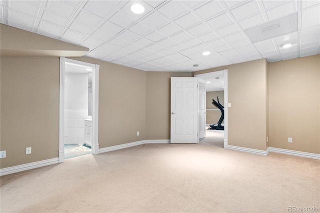 basement featuring light colored carpet