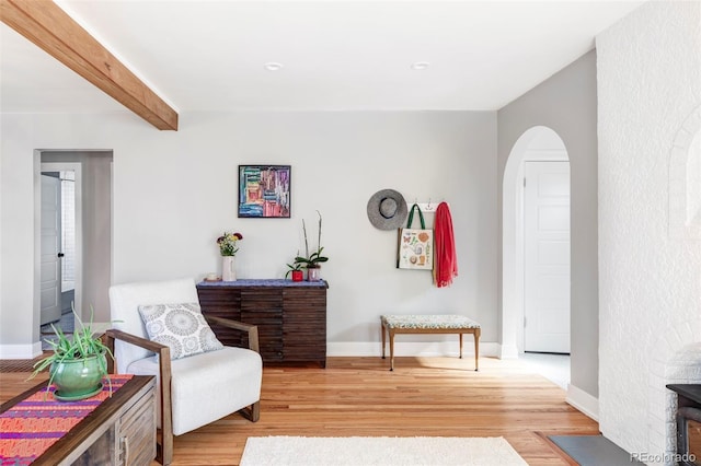 3509 N Monroe St, Denver, CO 80205 - sitting room featuring light wood finished floors, arched walkways, and beamed ceiling