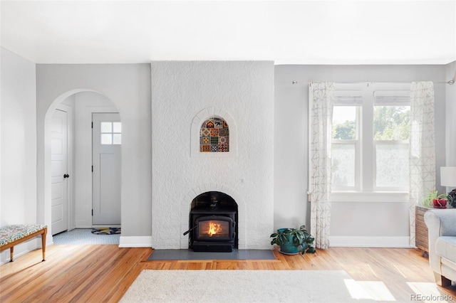 3509 N Monroe St, Denver, CO 80205 - unfurnished living room featuring wood finished floors, plenty of natural light, and arched walkways