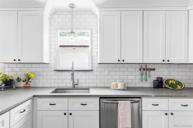 3509 N Monroe St, Denver, CO 80205 - kitchen with stainless steel dishwasher, white cabinetry, and decorative backsplash