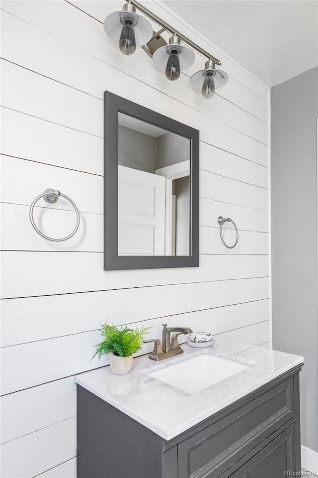 3509 N Monroe St, Denver, CO 80205 - bathroom featuring vanity and wooden walls