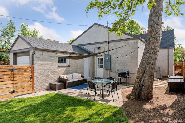 3509 N Monroe St, Denver, CO 80205 - rear view of property with brick siding, a shingled roof, a patio area, and outdoor lounge area