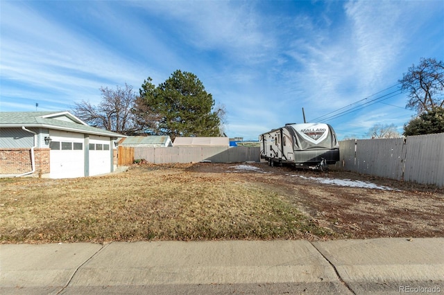 view of yard with a garage and fence