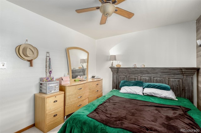 bedroom with baseboards, a ceiling fan, and light colored carpet