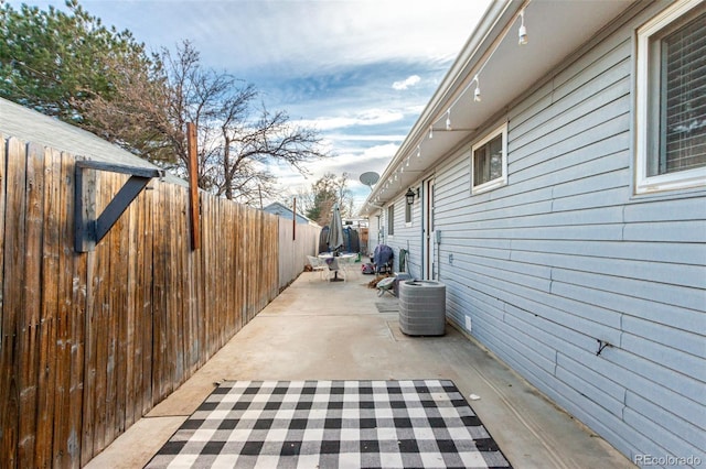 view of home's exterior with cooling unit, a patio area, and a fenced backyard