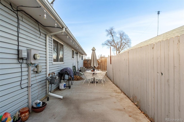 view of patio with a fenced backyard and outdoor dining space