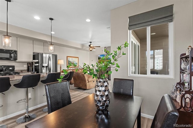 23534 E 5th Pl, Aurora, CO 80018 - dining area featuring light wood finished floors, ceiling fan, and recessed lighting