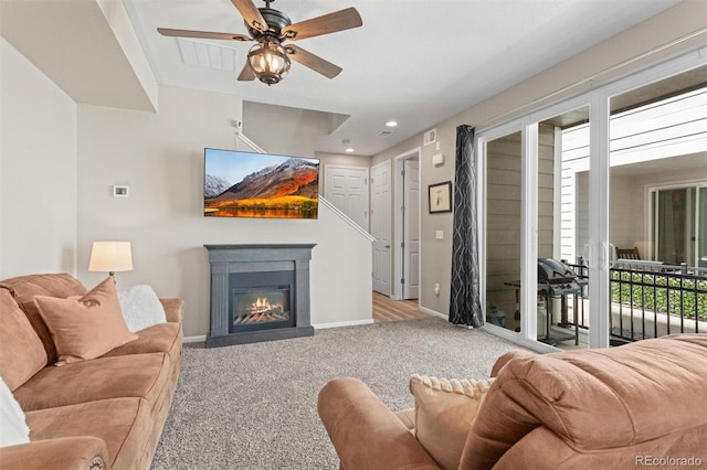 23534 E 5th Pl, Aurora, CO 80018 - living area with carpet flooring, healthy amount of natural light, ceiling fan, a glass covered fireplace, and recessed lighting