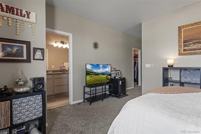 23534 E 5th Pl, Aurora, CO 80018 - bedroom with carpet floors, a walk in closet, and ensuite bath
