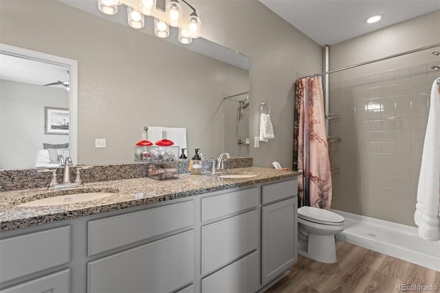 23534 E 5th Pl, Aurora, CO 80018 - full bath featuring wood finished floors, tiled shower, and double vanity
