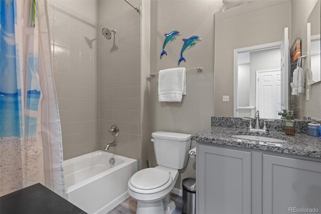 23534 E 5th Pl, Aurora, CO 80018 - bathroom featuring shower / bath combo with shower curtain, vanity, and wood finished floors