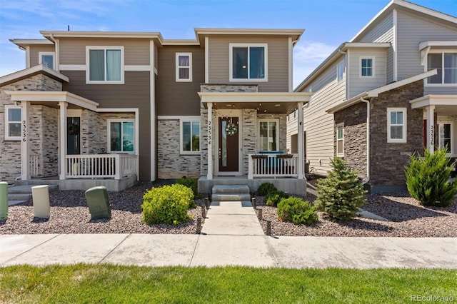 23534 E 5th Pl, Aurora, CO 80018 - view of front of home with a porch and stone siding