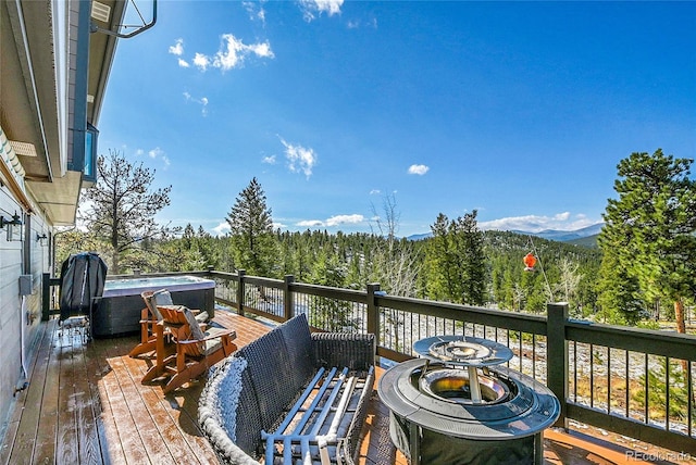 1567 Tapadero Rd, Bailey, CO 80421 - wooden deck with a hot tub, a wooded view, and a mountain view