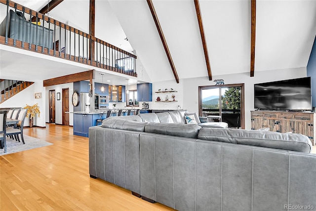 1567 Tapadero Rd, Bailey, CO 80421 - living room with high vaulted ceiling, light wood-type flooring, stairs, and beam ceiling