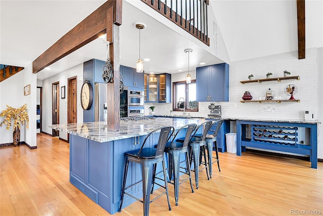 1567 Tapadero Rd, Bailey, CO 80421 - kitchen with blue cabinets, light wood-type flooring, decorative backsplash, a kitchen breakfast bar, and beam ceiling