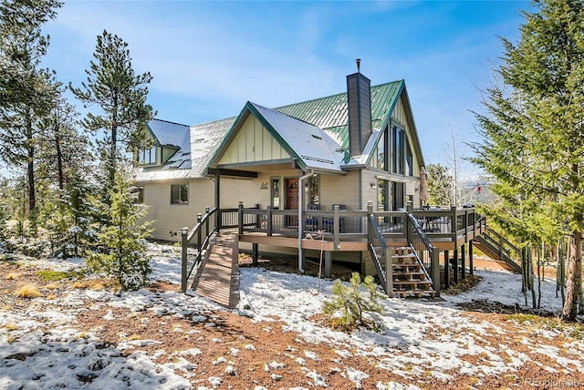 1567 Tapadero Rd, Bailey, CO 80421 - view of front of house with stairs, a chimney, and a wooden deck