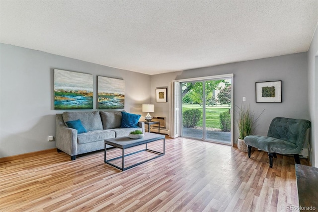13626 E Bates Ave Unit 110, Aurora, CO 80014 - living area with wood finished floors and a textured ceiling