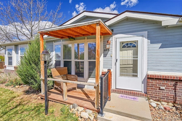 6631 E 78th Ave, Commerce City, CO 80022 - view of exterior entry featuring a wooden deck