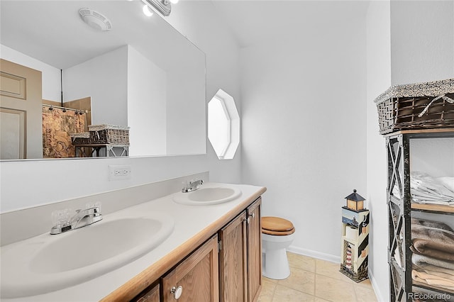 6631 E 78th Ave, Commerce City, CO 80022 - bathroom featuring double vanity, toilet, baseboards, and a sink