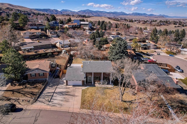 drone / aerial view featuring a residential view and a mountain view