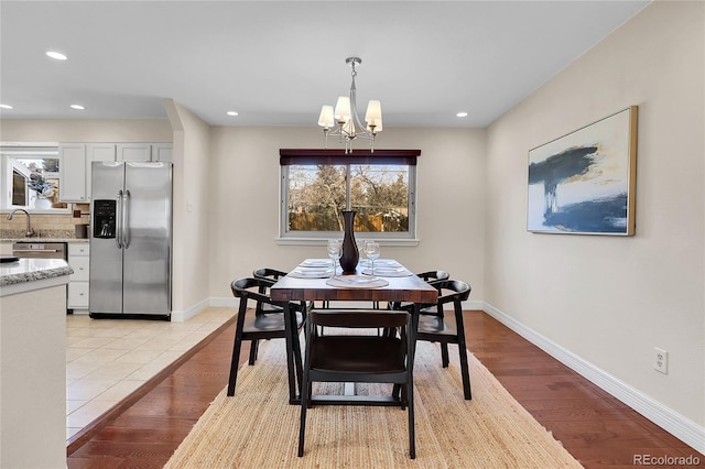 dining area with recessed lighting, light wood-style flooring, and baseboards